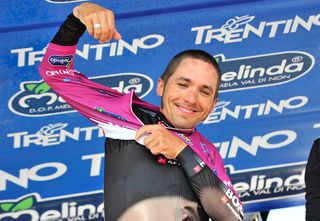 Cesare Benedetti pulls on the race leader's jersey at Giro del Trentino.