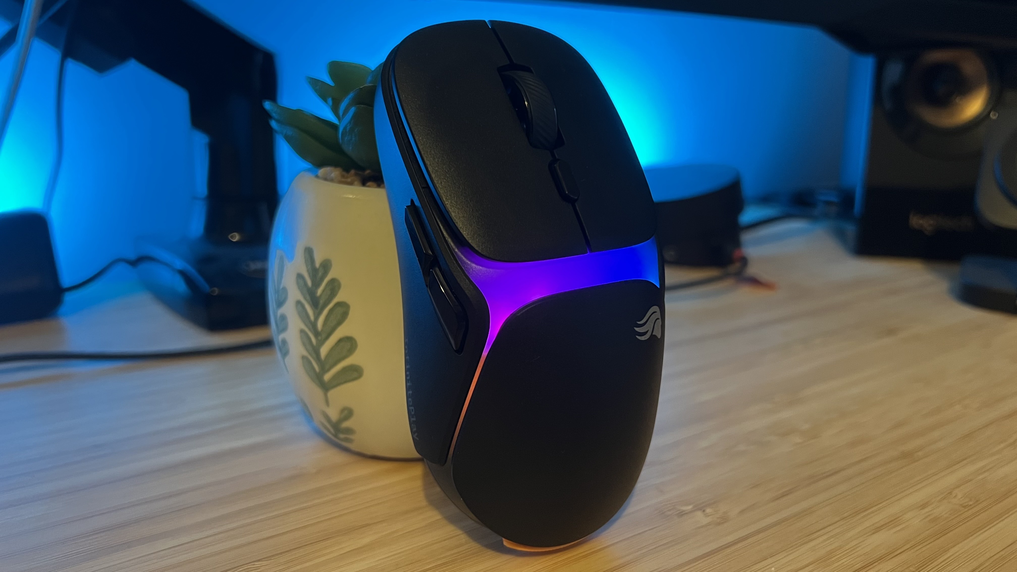 Side view of Glorious Model O 3 Wireless gaming mouse standing on a wooden desk