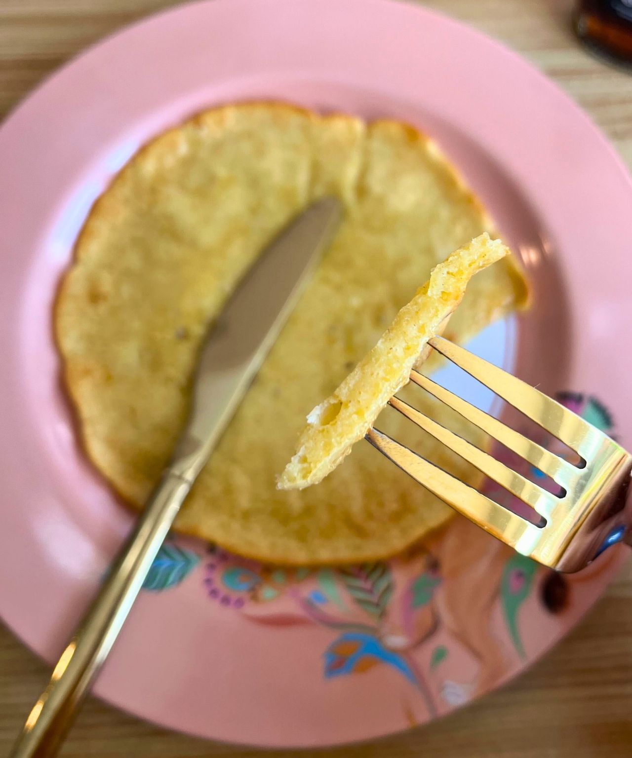 Air fryer pancake in section on fork showing it's thin