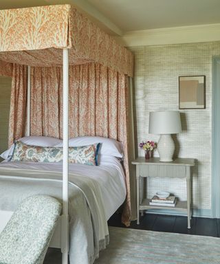 Four poster bed in bedroom with bedside table