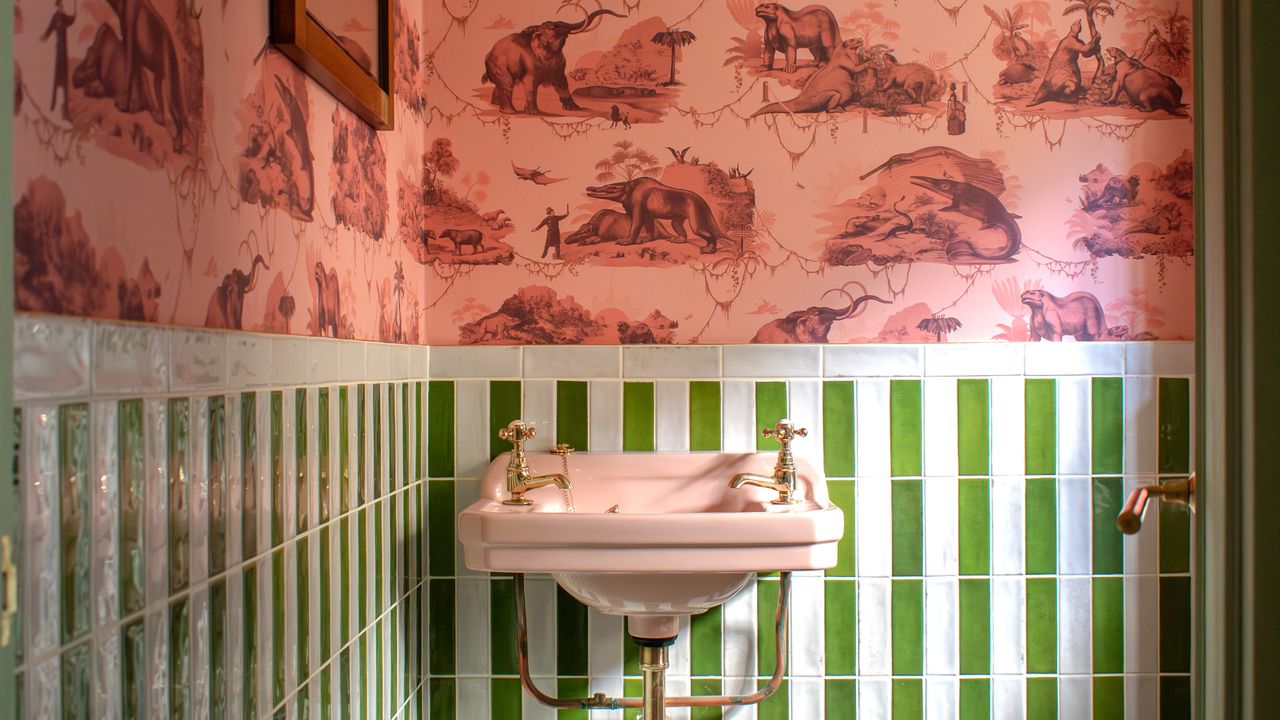 Bathroom with pink toile wallpaper and green tiles