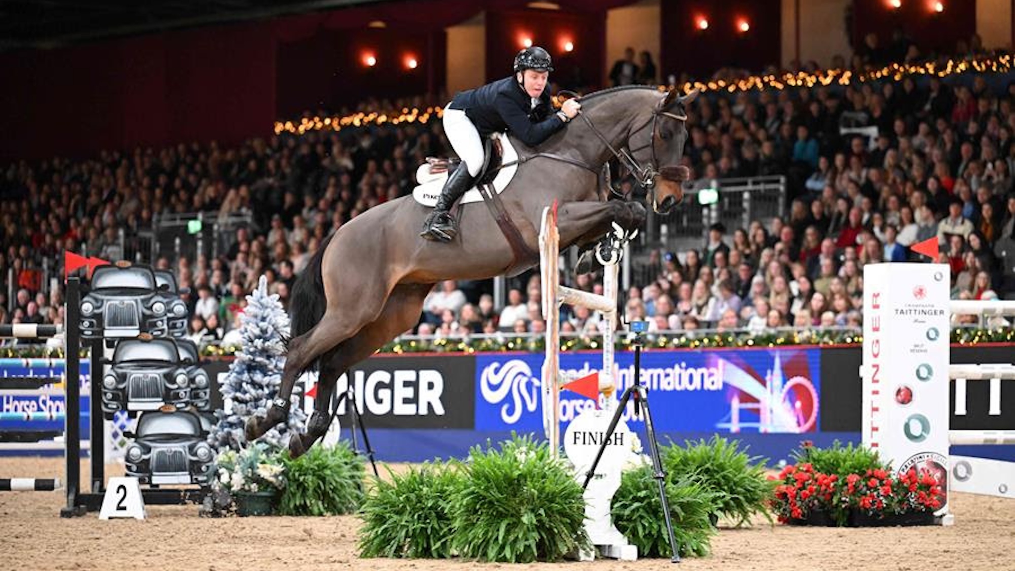 Matt Sampson jumps a vertical on a bay horse at the London International
