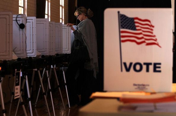 A woman votes.