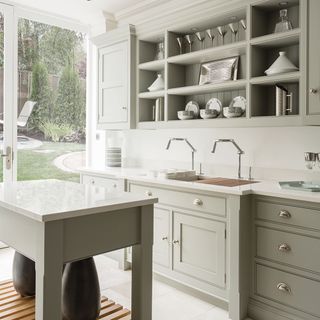 pale green grey shaker style kitchen with open shelving and island