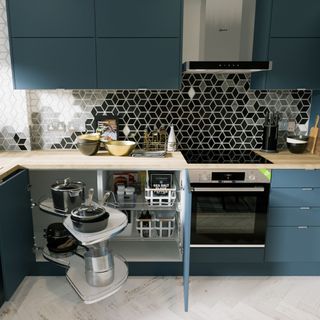 Dark blue kitchen cabinets with wooden tops and corner cupboard organiser