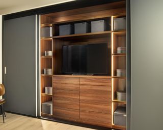 Beautiful fitted walnut wardobes that conceal a TV