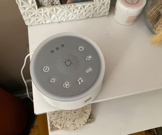 Dreamegg white noise machine on a bedside table