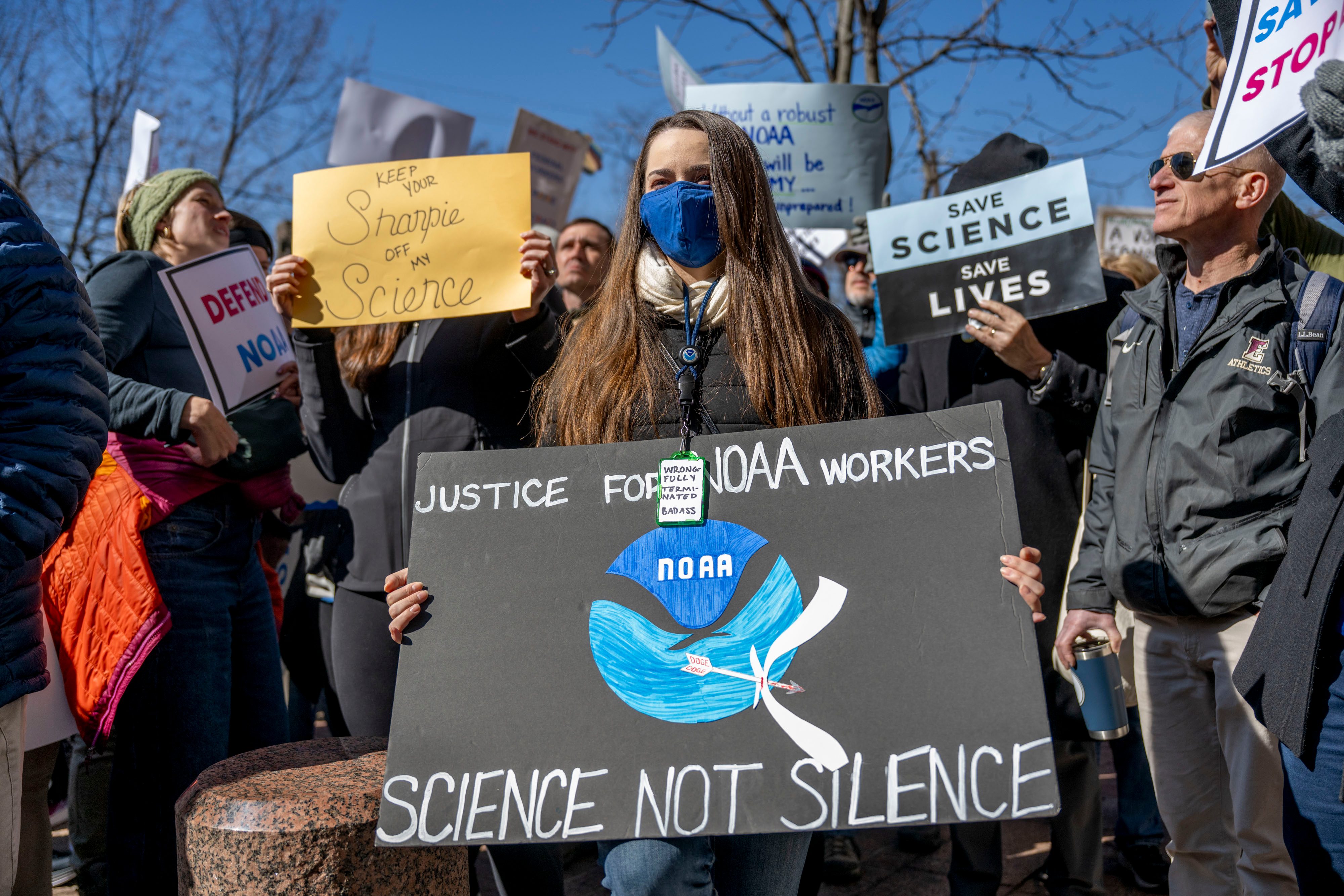 A person at a protest holding a sign that says 