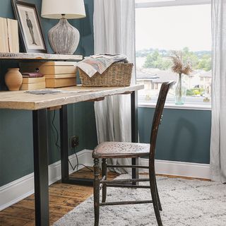 home office with blue walls and desk