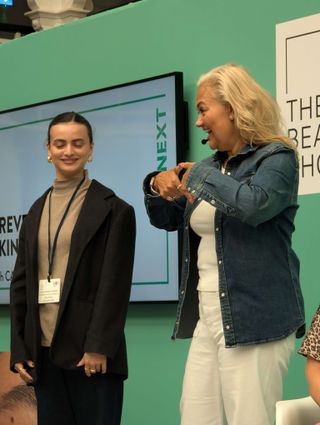 Caroline Hirons demonstrating skincare techniques on stage