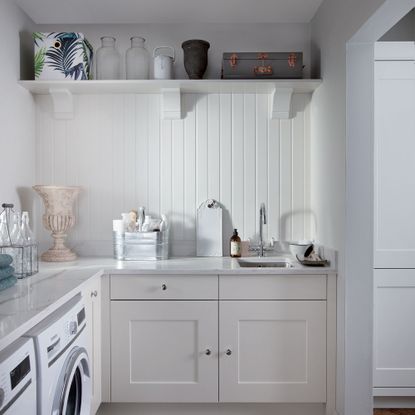 white utility room with panelled wall