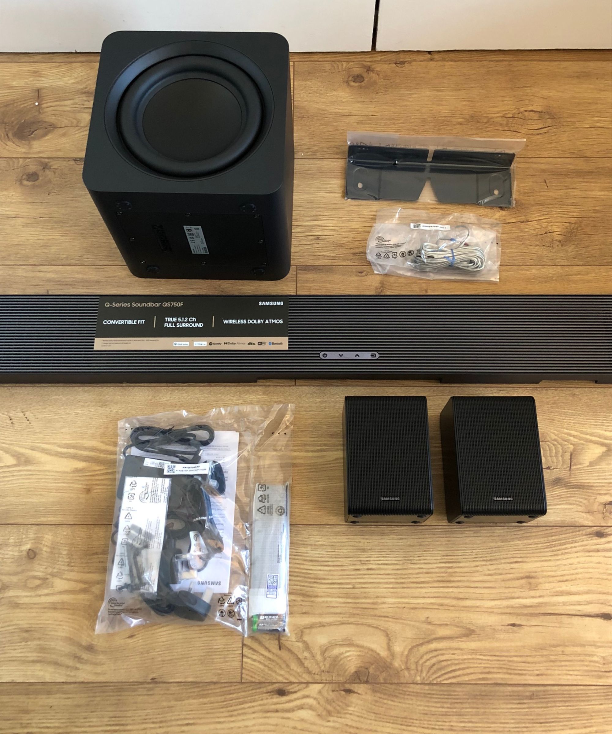 All components of the Samsung HW-QS750F soundbar on wooden floor in Dan Fauzi&#039;s home.
