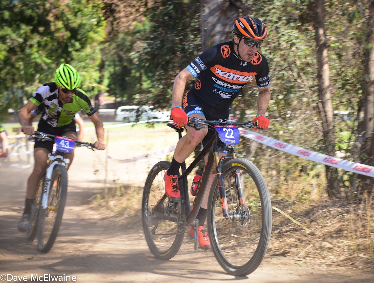 Spenser Paxson (Kona) climbing out of the saddle on lap four