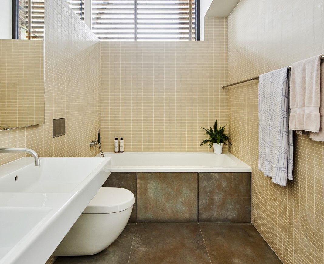 A porcelain bath connects to the studio and office rooms downstairs whilst overhead lighting shines into the room