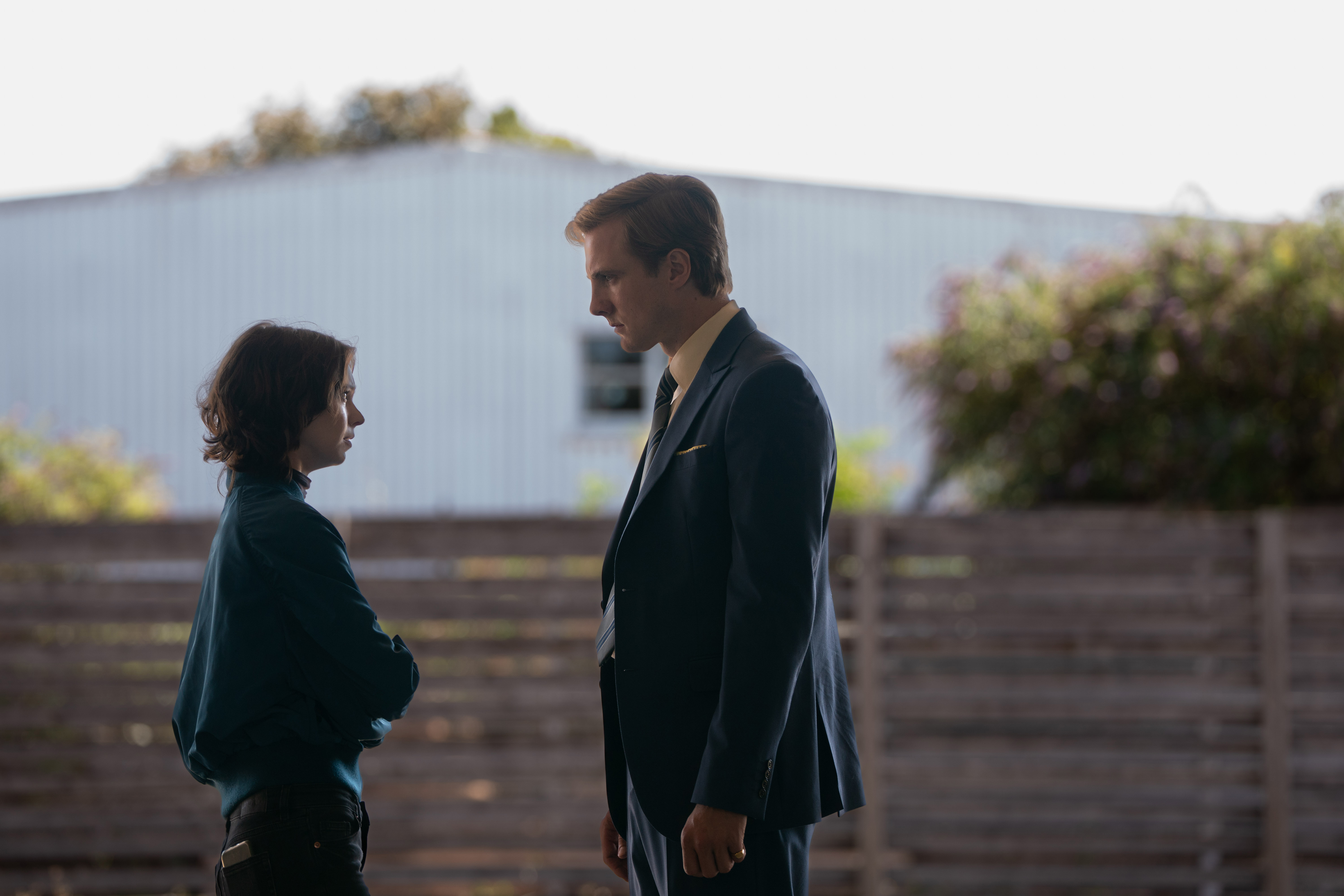 Emma Myers as Pip Fitz-Amobi and Henry Ashton as Max Hastings confronting each other on a rural street in A Good Girl's Guide to Murder: Season 2