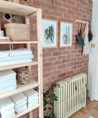 Exposed brick wall behind radiator in utility room