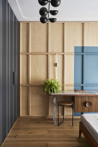 A bedroom with a color swatch on a wooden wall