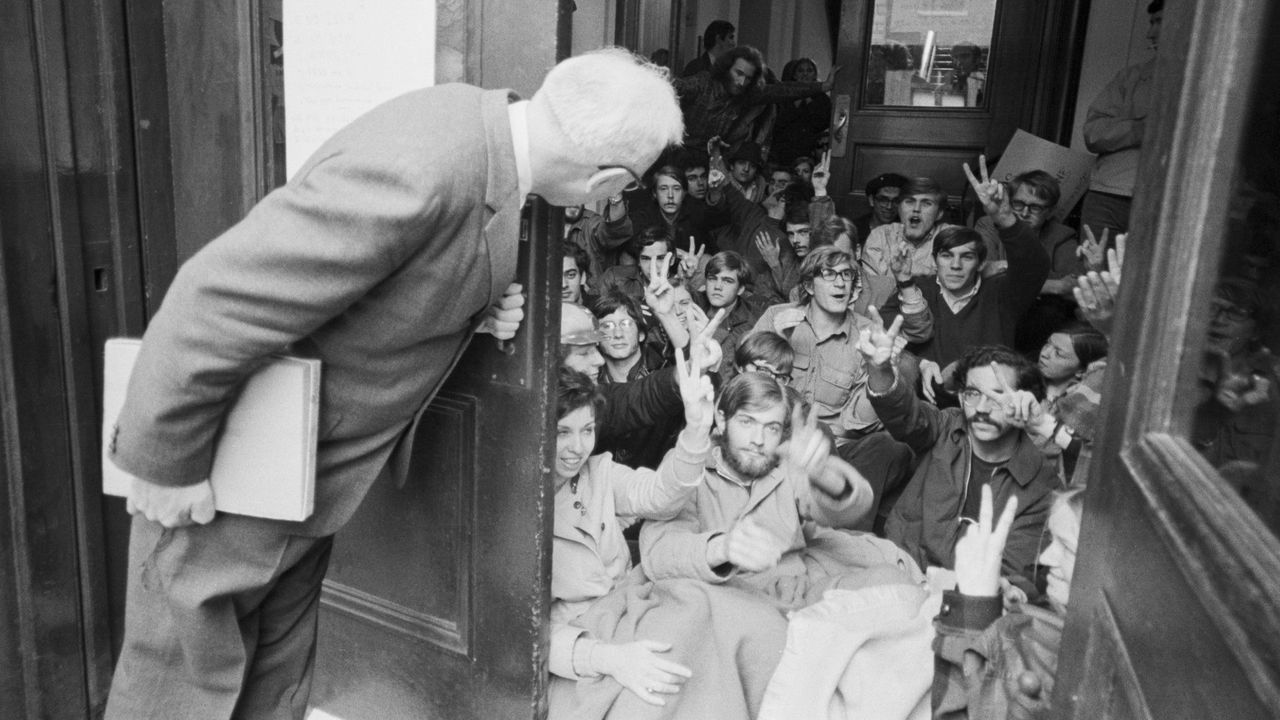 At Columbia University in April 1968, a professor opens a door to find an entrance blocked during student sit-ins