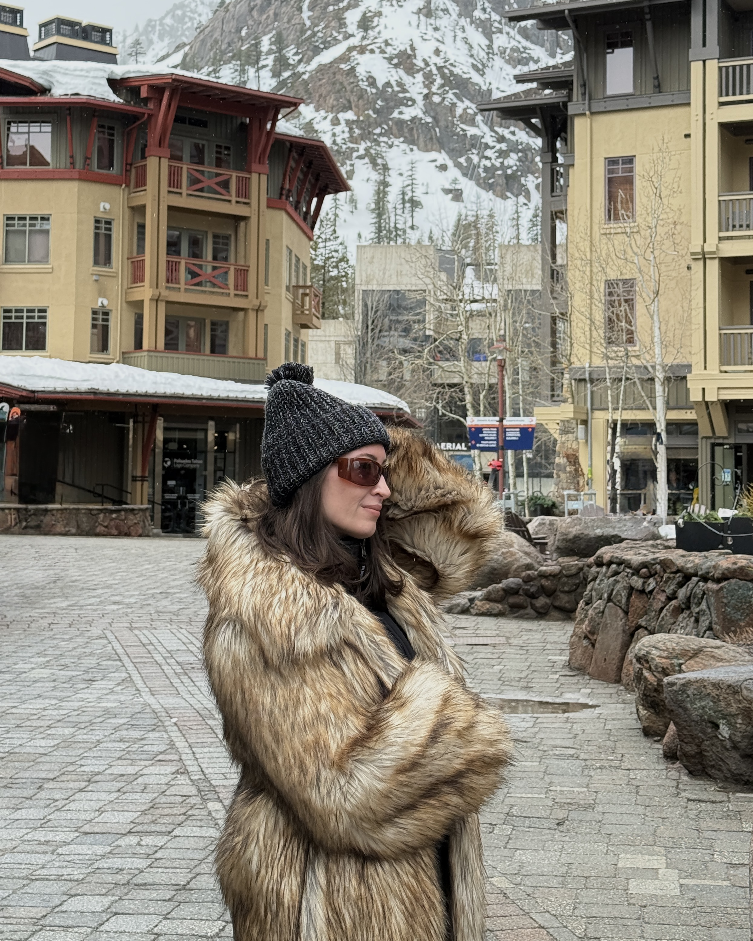Bella Gerard in her apr&egrave;s outfit with a faux fur coat and beanie