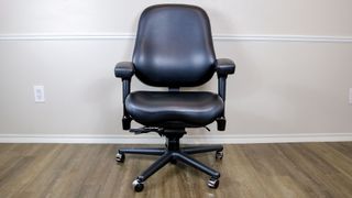 A BodyBilt Classic 2500 Series office chair against a wall