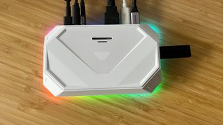 Top view of JSAUX RGB Docking Station with cables connected on a wooden desk
