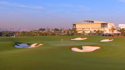 A general view of Al Zorah Golf & Yacht Club's ninth green and clubhouse in the background
