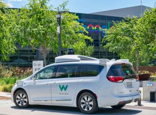 A self-driving Waymo car outside the Google offices 
