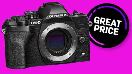 Olympus OM-D E-M10 black body on purple backdrop with Great Price badge