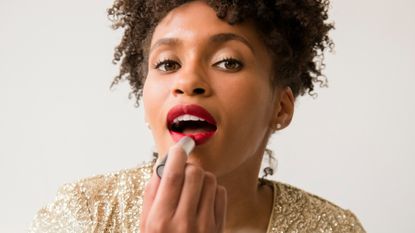 woman applying lipstick