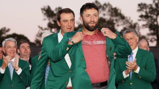 Jon Rahm of Spain is awarded the Green Jacket by 2022 Masters champion Scottie Scheffler of the United States during the Green Jacket Ceremony after Rahm won the 2023 Masters Tournament at Augusta National Golf Club