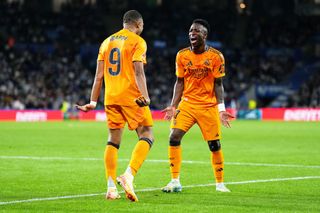 Kylian Mbappe of Real Madrid celebrates scoring his team's second goal with teammate Vinicius Junior during the LaLiga match between Real Sociedad and Real Madrid CF at Reale Arena on September 14, 2024 in San Sebastian, Spain.