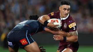 Valentine Holmes of the Maroons is tackled during game one of the 2023 State of Origin rugby league 