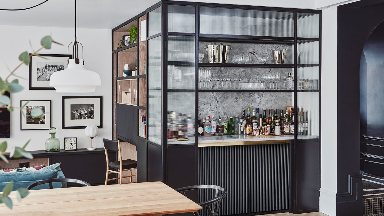 Black home bar cabinetry in dining area