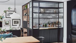 Black home bar cabinetry in dining area