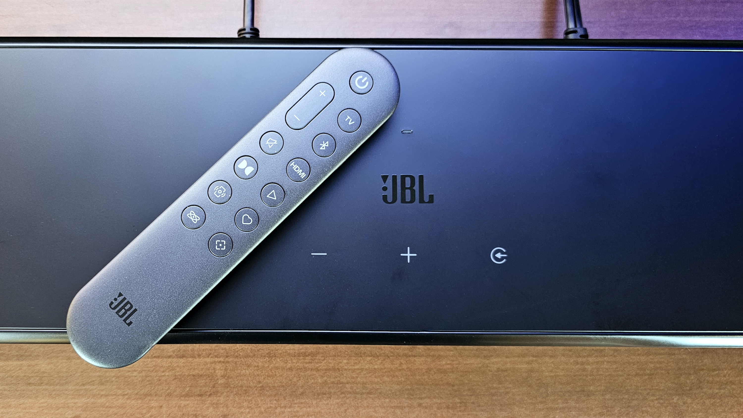 JBL Bar 1000MK2 overhead shot showing top surface controls and remote control