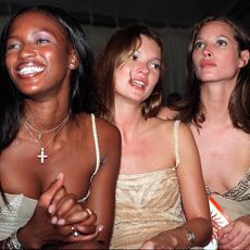 Naomi Campbell (L), Kate Moss (C) and Christy Turlington attend a charity auction after a presentation of Giani Versace's haute couture collection at the Presidential Guest House in Cape Town 14 February. 