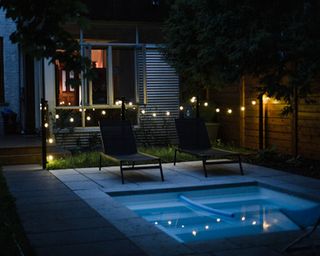 hot tub with festoon lights at night