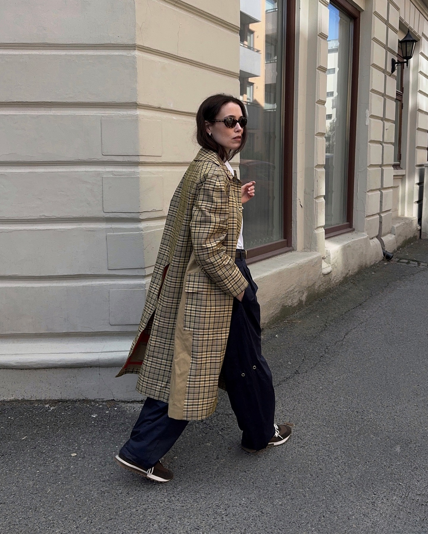 Influencer wearing a checked trench coat