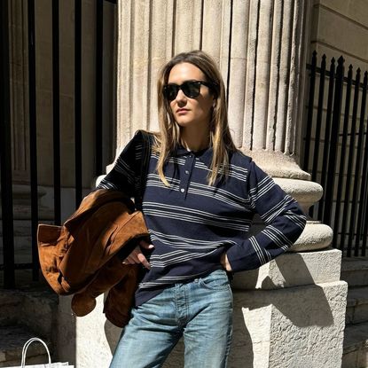 a woman wearing a striped polo shirt and blue 