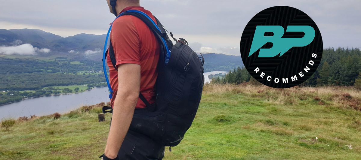 Side view of mountain biker wearing the Osprey Escapist pack