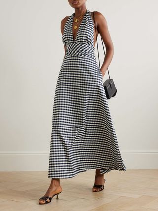 a model wears a black and white gingham halter dress