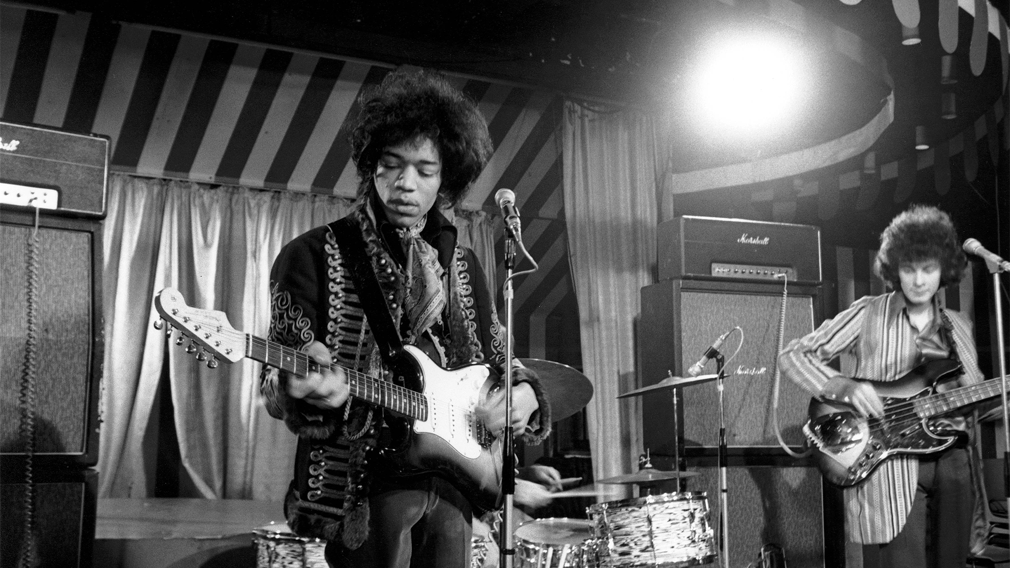 Jimi Hendrix Experience - L-R: Jimi Hendrix, Noel Redding - performing live onstage at the London Marquee while filming for the German TV Show 'Beat Club', with Marshall amplifiers behind, March 2, 1967. The group performed “Hey Joe” and “Purple Haze."