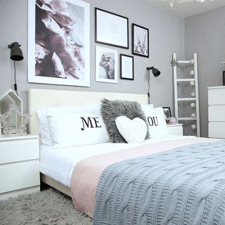 bedroom with grey wall and ladder and faux fur rug and picture frame