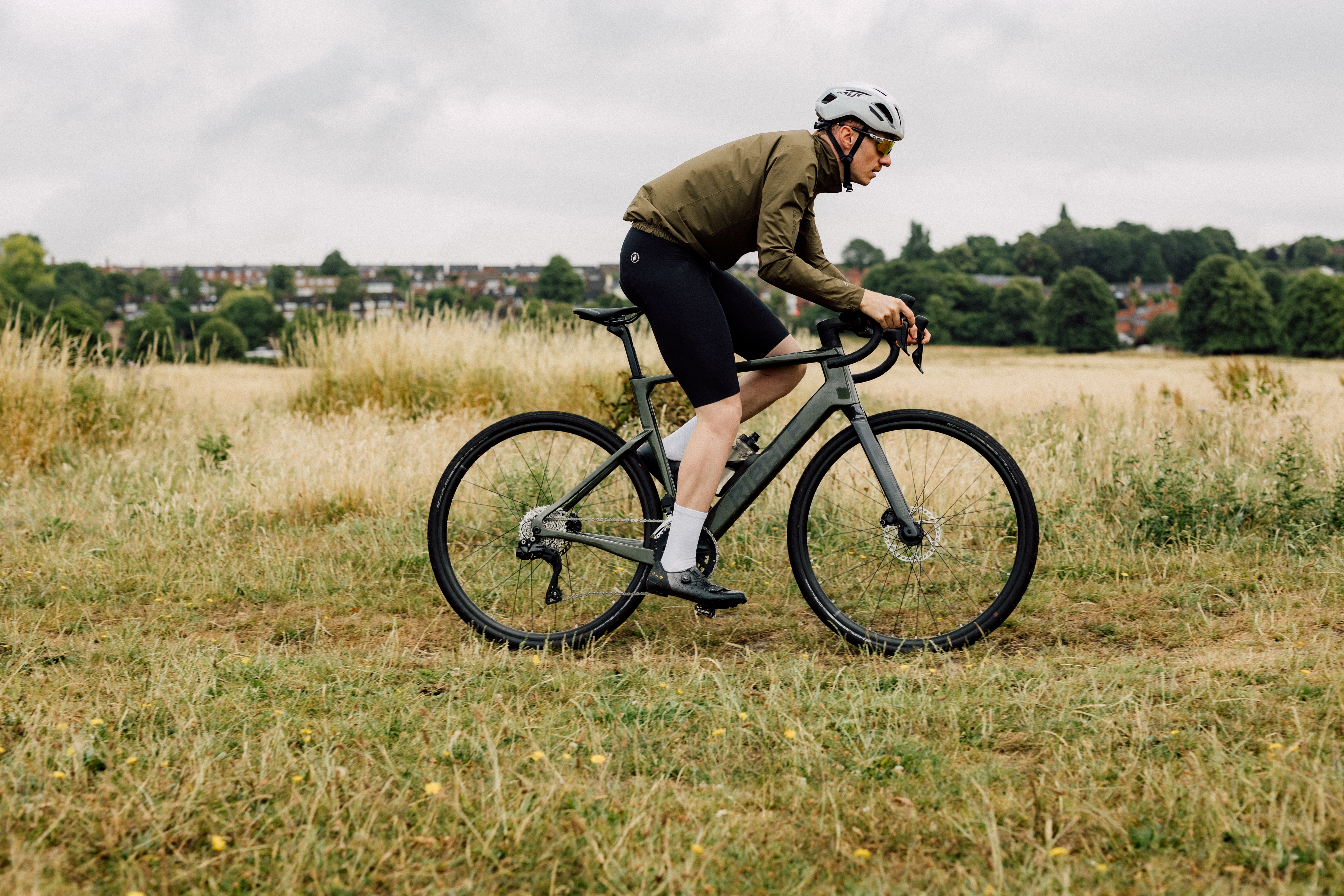 Ribble e-bike in a grassy landscape near a town