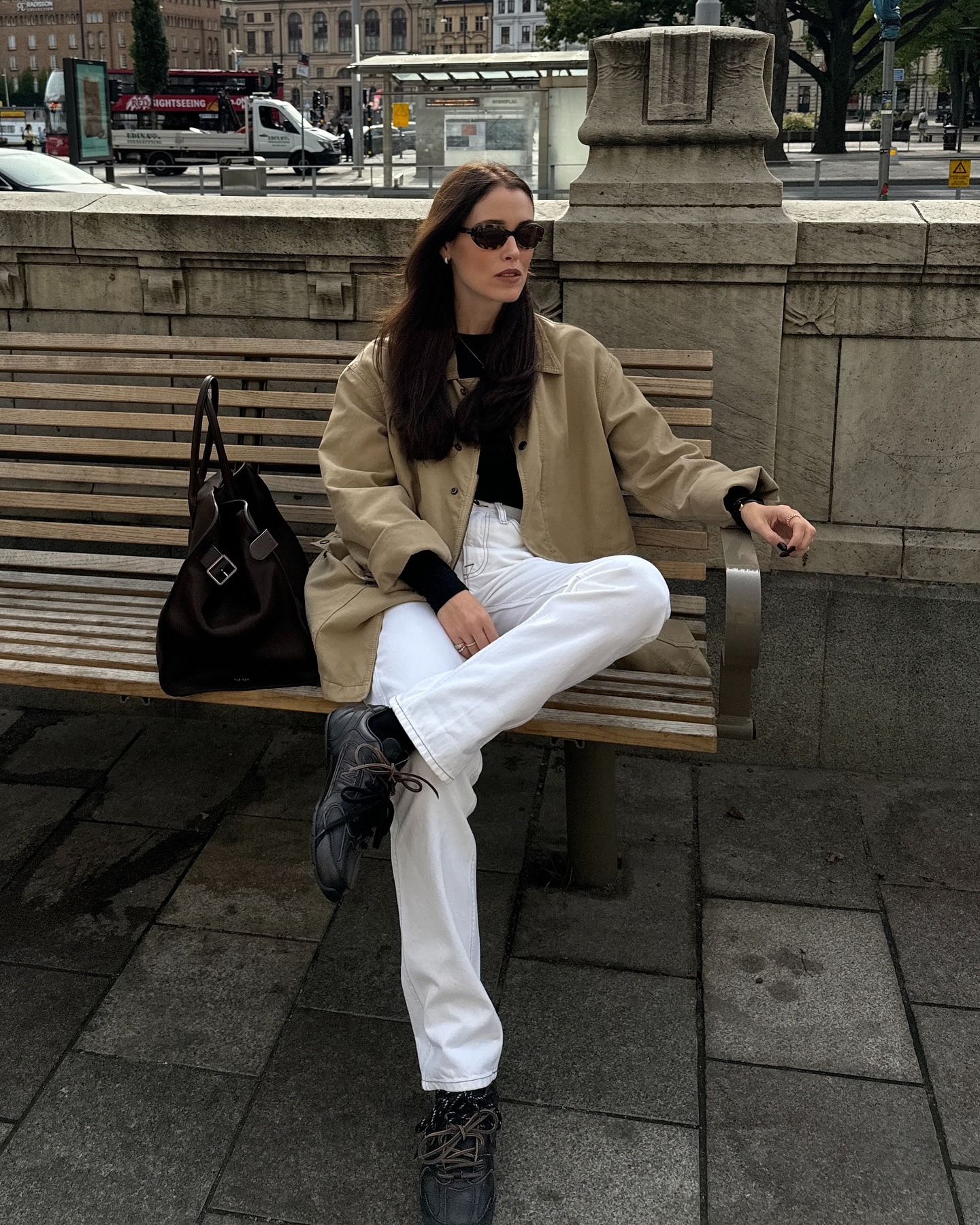 Influencer @annabelrosendahl wears white jeans with a barn jacket and black Miu Miu New Balance trainers.
