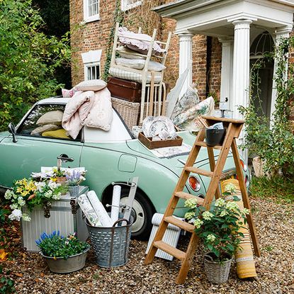 house exterior with ladder and car