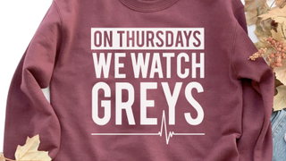 A Grey's Anatomy sweatshirt reads "On Thursdays we watch Grey's."