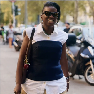 Nikki Ogunnaike wearing a button down shirt and a tube top 