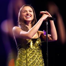 Olivia Rodrigo onstage in New York City wearing custom Miu Miu