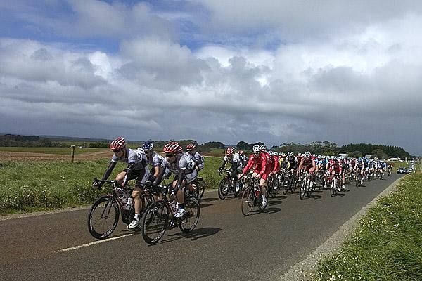 The peloton roll through the farming region near Smithton around two minutes behind a lead group of four riders.